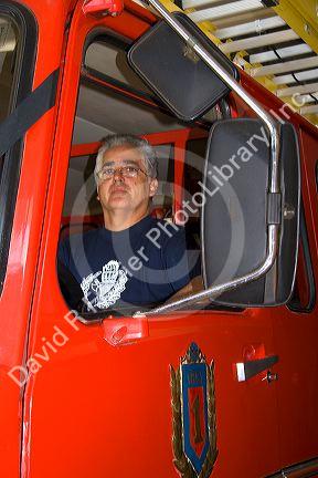 Chilean firefighter sitting in a fire truck at Valparaiso, Chile.