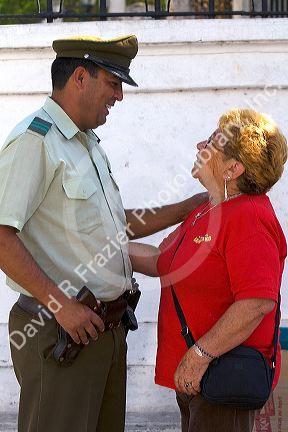 Woman greeting a Chilean police officer at Valparaiso, Chile.