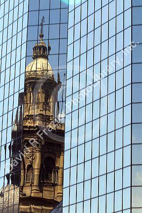 Reflection of the Metropolitan Cathedral in a modern office building in the Plaza de Armas in Santiago, Chile.
