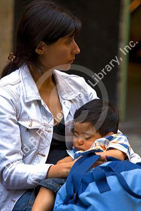 Mother and sleeping child in Santiago, Chile.
