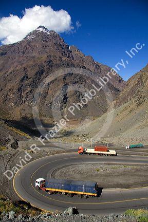 Trucks drive on switchback roads in the Andes Mountain Range in Chile.