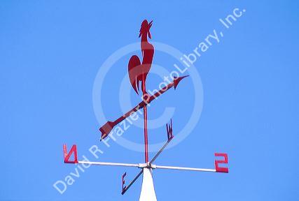 weathervane atop barn indicates wind direction.