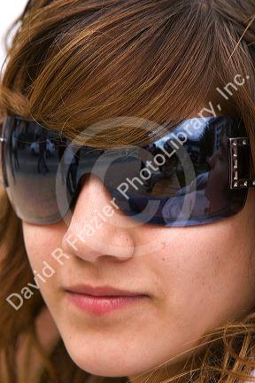 Portrait of a teenage girl wearing sunglasses at Ushuaia on the island of Tierra del Fuego, Argentina.