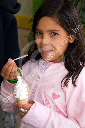 Girl eating an ice cream cone at Ushuaia on the island of Tierra del Fuego, Argentina.