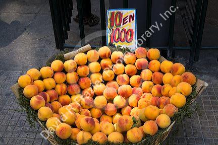 Basket of peaches being sold on the street in Santiago, Chile.