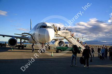 Passengers disembark an airplane at the El Calafate International Airport in Patagonia, Argentina.