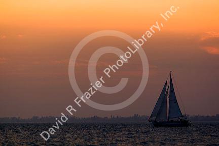 Sailboat and sunset at Fort Myers Beach on Estero Island in Lee County, Florida.