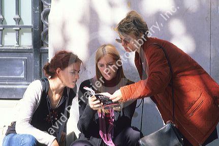 Women looking at a guide book in Paris, France.