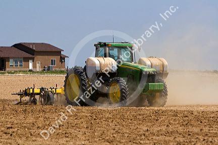 Tractor injecting herbicide into crop soil in Canyon County, Idaho.