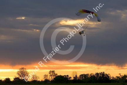 Powered parachute flying at sunset in Eaton County, Michigan.