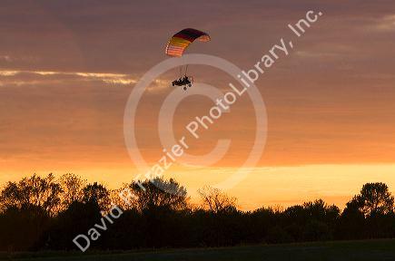 Powered parachute flying at sunset in Eaton County, Michigan.