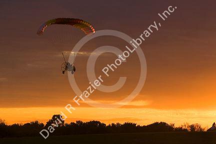 Powered parachute flying at sunset in Eaton County, Michigan.