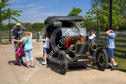 Children play on a Ford Model T in Greenfield Village at The Henry Ford in Dearborn, Michigan.