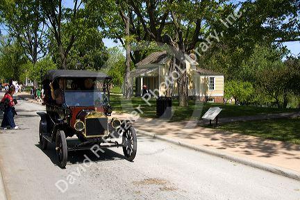 Visitors ride in a Ford Model T in Greenfield Village at The Henry Ford in Dearborn, Michigan.