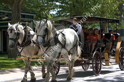Children ride in a horse drawn taxi in Greenfield Village at The Henry Ford in Dearborn, Michigan.
