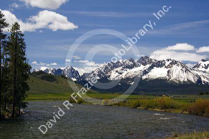 The Salmon River flowing through the Sawtooth Valley below the Sawtooth Mountain Range near Stanley, Idaho.
