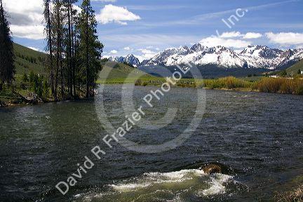 The Salmon River flowing through the Sawtooth Valley below the Sawtooth Mountain Range near Stanley, Idaho.