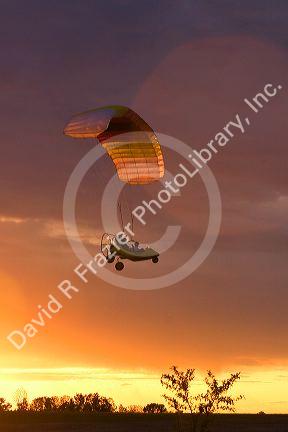 Powered parachute flying at sunset in Eaton County, Michigan.