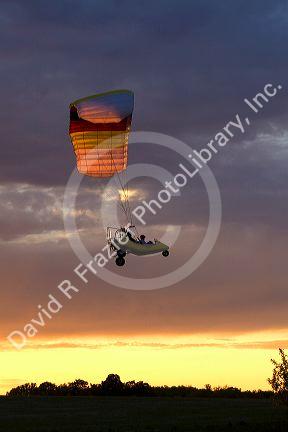 Powered parachute flying at sunset in Eaton County, Michigan.