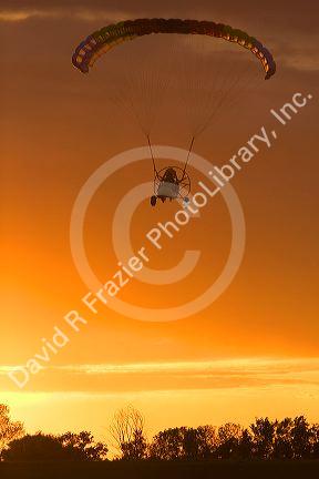 Powered parachute flying at sunset in Eaton County, Michigan.