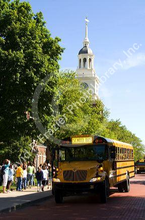 School bus parked in front of the Independence Hall replica at The Henry Ford Museum in Dearborn, Michigan.