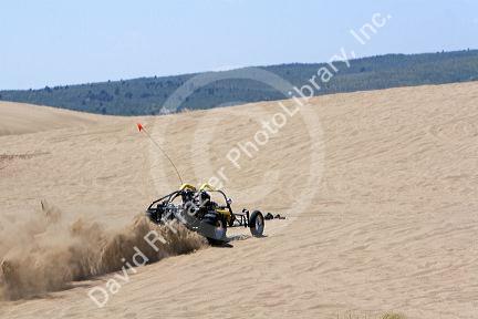 Dune buggy driving on sand dunes at St. Anthony, Idaho.