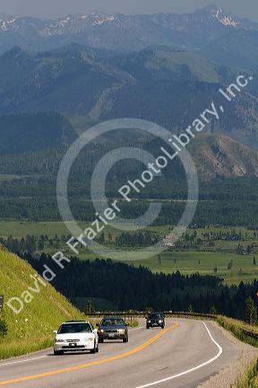Vehicles travel over the high mountain Teton Pass on Wyoming Highway 22 near the state border of Wyoming and Idaho.