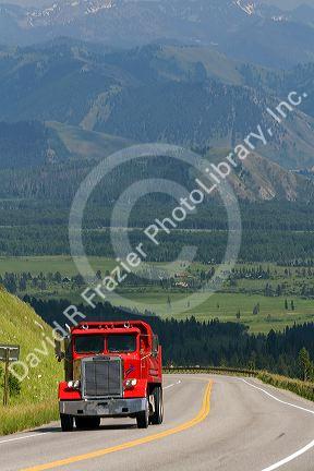 Dump truck traveling over the high mountain Teton Pass on Wyoming Highway 22 near the state border of Wyoming and Idaho.