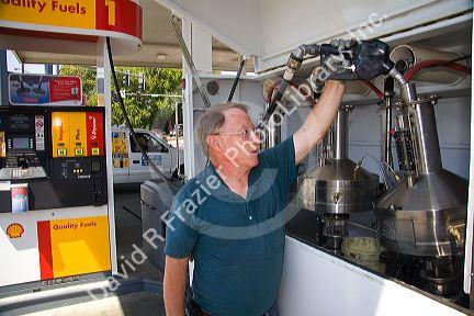Bureau of Weights and Measures inspector testing gasoline octane rating and gas pump accuracy in Boise, Idaho.
