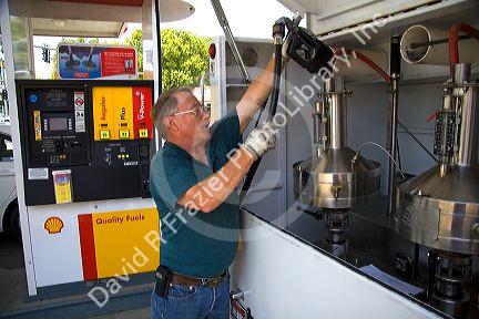 Bureau of Weights and Measures inspector testing gasoline octane rating and gas pump accuracy in Boise, Idaho.