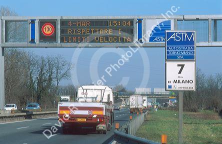 Speed limit signs change with conditions along Autostrada near Milan, Italy.