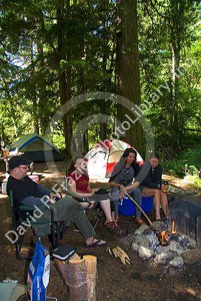 Campers is by a campfire in the North Cascades National Park, Washington.