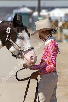 Girl showing her Pinto horse to 4-H judges at the Western Idaho Fair in Boise, Idaho.
