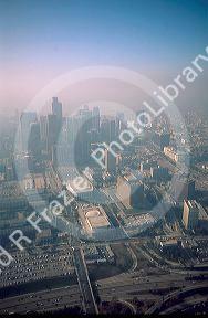 Aerial view of downtown Los Angeles shrouded in smog.