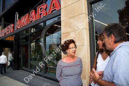 People socialize in front of a supermarket located in the city of Donostia-San Sebastian, Guipuzcoa, Basque Country, Northern Spain.