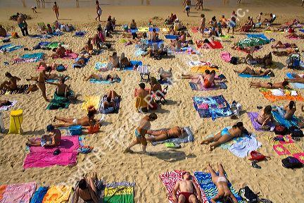 People sunbathe on the beach in the city of Donostia-San Sebastian, Guipuzcoa, Basque Country, Northern Spain.