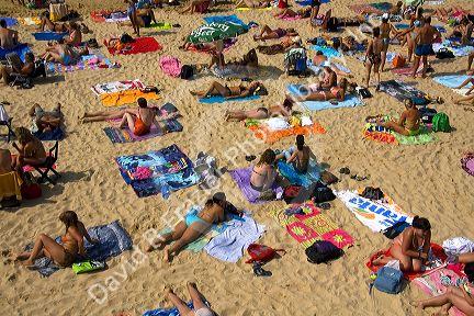 People sunbathe on the beach in the city of Donostia-San Sebastian, Guipuzcoa, Basque Country, Northern Spain.