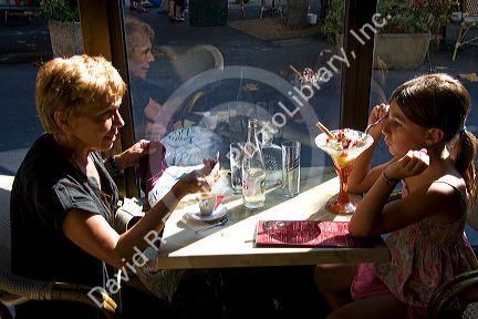 Grandmother and granddaughter dining at a restaurant in the town of Saint-Jean-de-Luz, Pyrenees-Atlantiques, French Basque Country, Southwest France. MR