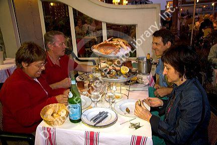 People dine on seafood at a restaurant in Saint-Jean-de-Luz, Pyrenees Atlantiques, French Basque Country, Southwest France.