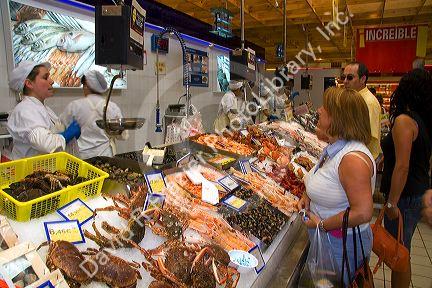 Customers shop for seafood inside the Eroski supermarket in the town of Castro Urdiales, Cantabria, northern Spain.