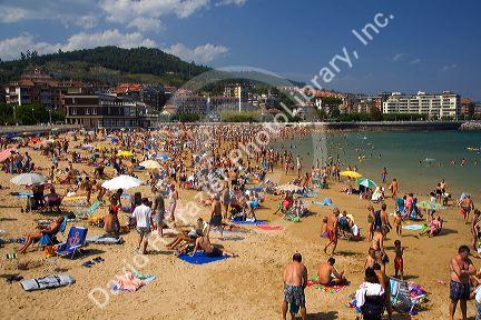 Crowded beach scene at Castro Urdiales, Cantabria, northern Spain.