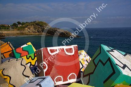 Painted cement blocks in the harbor at Llanes, Asturias, Spain.