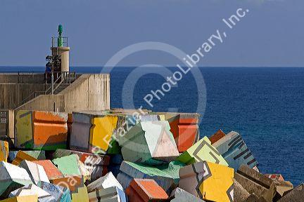 Painted cement blocks in the harbor at Llanes, Asturias, Spain.