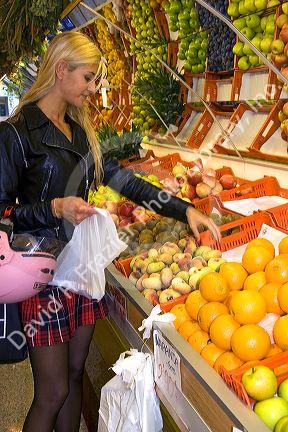Spanish woman shopping at a Fruiteria in the city of Donostia-San Sebastian, Guipuzcoa, Basque Country, Northern Spain.