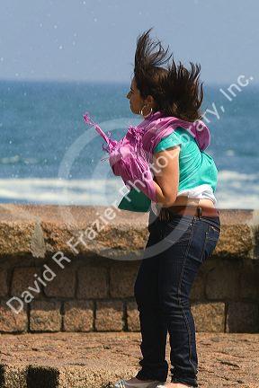 Air from a blowhole lifts a girls hair and clothing in the city of Donostia-San Sebastian, Guipuzcoa, Basque Country, Northern Spain.
