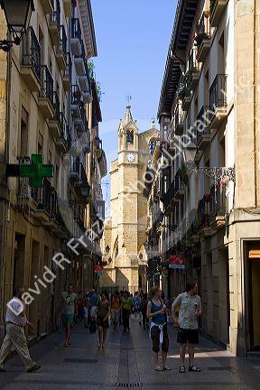 People shopping along a walking street in the city of Donostia-San Sebastian, Guipuzcoa, Basque Country, Northern Spain.
