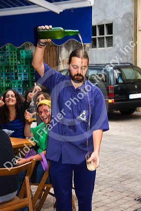 Server pouring cider at a cidereria in the town of Ribadesella, Asturias, northern Spain.