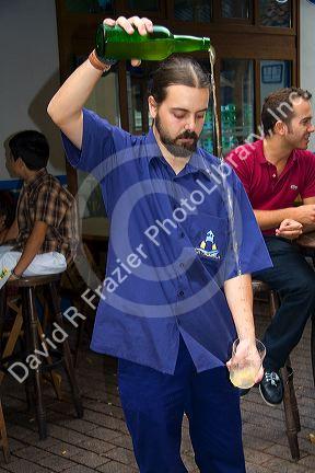 Server pouring cider at a cidereria in the town of Ribadesella, Asturias, northern Spain.