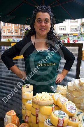 Spanish woman selling cheese at an outdoor market in the town of Cangas de Onis, Asturias, northern Spain.