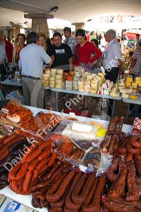 Vendors selling cheese and meats at an outdoor market in the town of Cangas de Onis, Asturias, northern Spain.